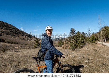 Goriano Sicoli, Italy A sporty man with a helmet on an electric mountain bike in the countryside.