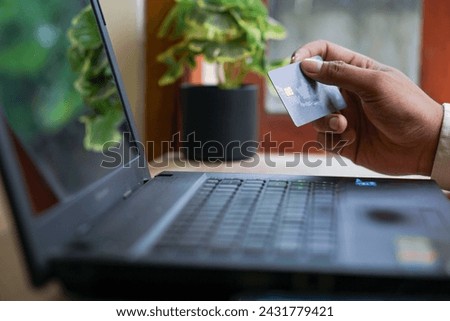 Online payment,Man's hands holding a credit card and using laptop for online shopping