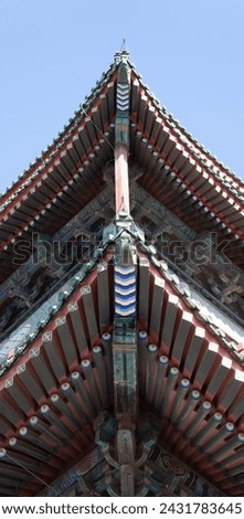 Traditional Chinese architecture with dougong brackets under the eaves, embodying intricate craftsmanship and elegance.