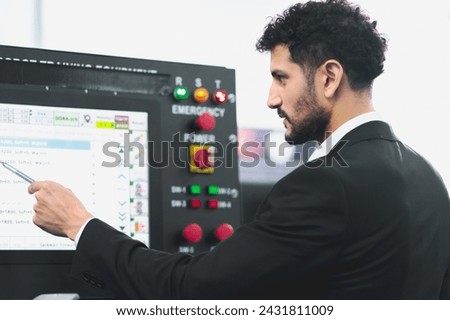 A Professional female engineer and Male CEO are working on PLC Control panel CNC machine. Expertise and technician repairman is maintenance, programming, and improve the automatic innovation machinery