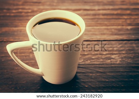 Coffee cup on wooden table in coffee shop - Vintage effect style pictures