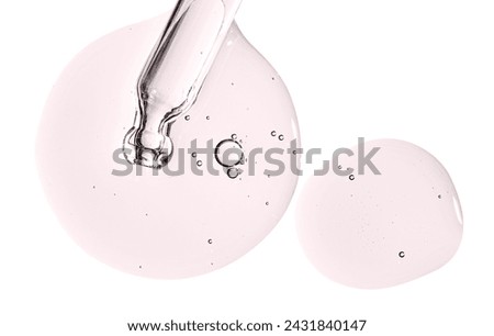Pipette and drops of cosmetic serum for the skin. Liquid body care product. Isolated on a white background. Royalty-Free Stock Photo #2431840147