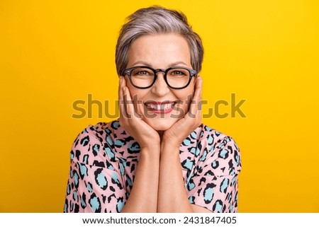 Photo portrait of attractive pensioner woman touch cheeks dreamy dressed stylish leopard print clothes isolated on yellow color background