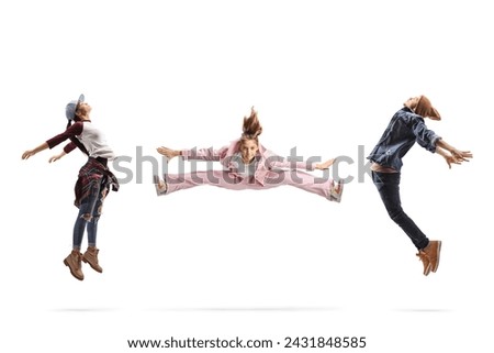 Girl leaping in the air between a male and female dancers isolated on white background