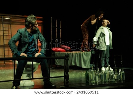 Actors and actresses play a modern performance of the show on the stage of the theater Royalty-Free Stock Photo #2431859511