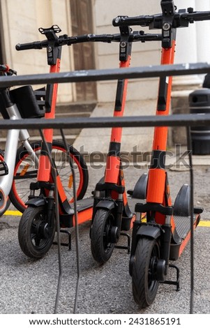 electric scooter and electric bicycle rental subscription service in urban parking in city - eco sustainable urban transport concept Royalty-Free Stock Photo #2431865191