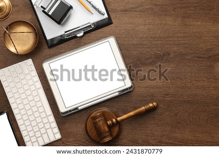 Flat lay composition with modern tablet on wooden table. Space for text
