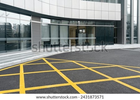 empty concrete floor in front of modern buildings in the downtown street. copy space for parking lot. Royalty-Free Stock Photo #2431873571