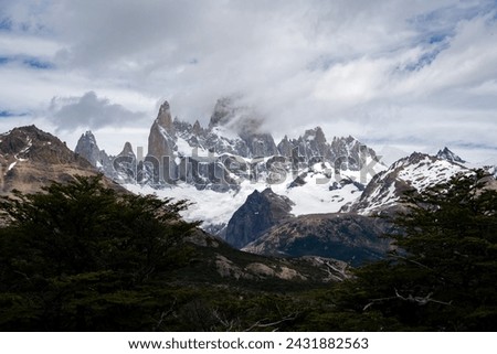 Picture with trees in the foreground and the Fitz Roy in the background during the summer in patagonia Argentina