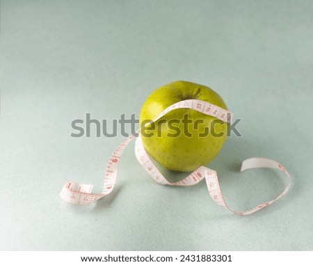 diet concept, an apple with centimeter tape