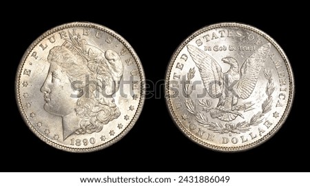 Obverse (heads) and reverse (tails) of U.S. 1890-S Morgan silver dollar isolated on black background. Brilliant uncirculated with slight gold toning and bag marks. Minted in San Francisco. Royalty-Free Stock Photo #2431886049