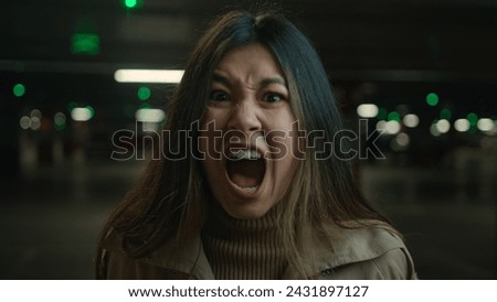 Mad angry crazy Asian korean chinese japanese girl shout in car parking furious woman annoyed businesswoman client speak loud screaming talk solve conflict feel anger rage talking scream webcam view Royalty-Free Stock Photo #2431897127