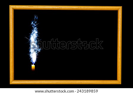 wood frame  Flakes blue candle on the black background