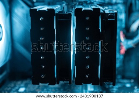 Detail of the interior of the PC gamer case. Motherboard, CPU tower cooling, memory, graphic card and RGB fans. professional gaming computer. Gaming PC with RGB LED lights hardware. Royalty-Free Stock Photo #2431900137
