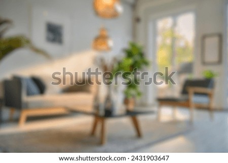 Blurred view of modern living room with sofa and soft bench. room interior with  couch, armchair and coffee table or shelving units. stylish living room. comfortable workplace near big window. Royalty-Free Stock Photo #2431903647