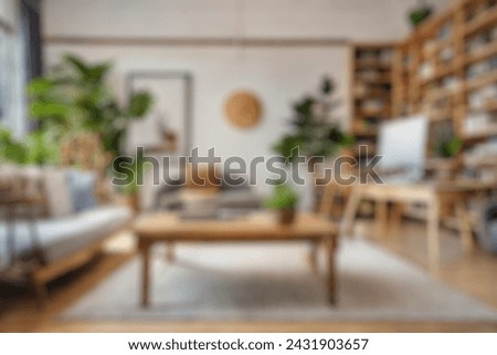 Blurred view of modern living room with sofa and soft bench. room interior with  couch, armchair and coffee table or shelving units. stylish living room. comfortable workplace near big window. Royalty-Free Stock Photo #2431903657