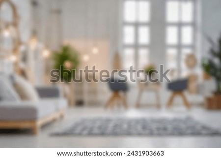 Blurred view of modern living room with sofa and soft bench. room interior with  couch, armchair and coffee table or shelving units. stylish living room. comfortable workplace near big window. Royalty-Free Stock Photo #2431903663