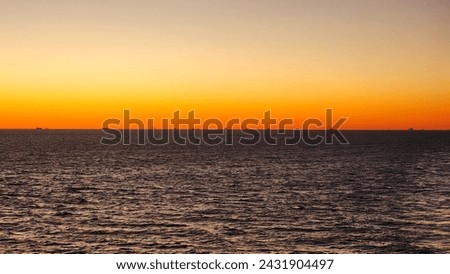 This is a picture of a sunset, taken during the spring months, while sailing through the ocean.