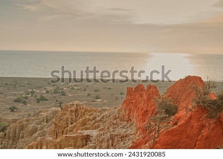 Standing atop a cliff, witness the vast ocean stretching out below, waves crashing against jagged rocks. The sea meets the sky on the horizon, a breathtaking scene of natures power and beauty.