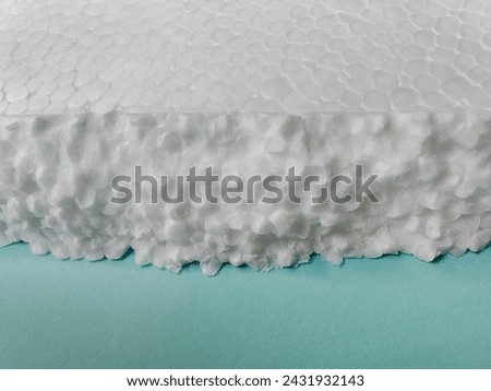 pieces of white styrofoam on blue cardboard. Royalty-Free Stock Photo #2431932143