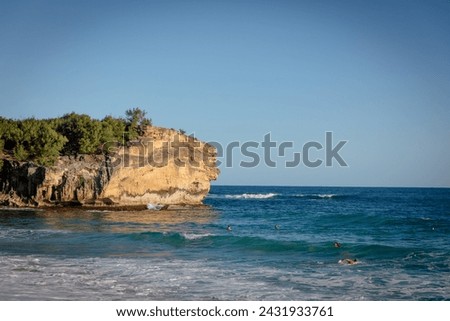 Cliff at the Shipwreck Beach on Kauai, known for surfing and sunset viewing popular spot for cliff jumping, at sunset. Beach at Grand Hyatt Kauai Resort  Spa Royalty-Free Stock Photo #2431933761
