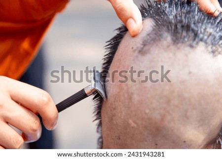 Ordination ceremony and Hair shaving  before ordination of Buddhist monks Royalty-Free Stock Photo #2431943281