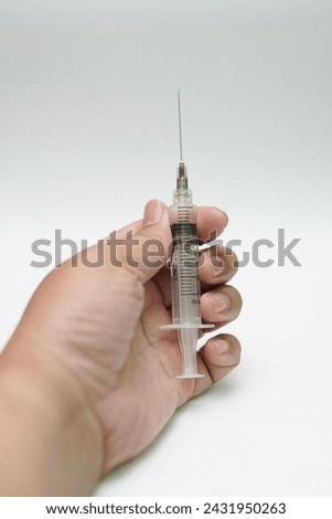 the syringe in my hand with white background