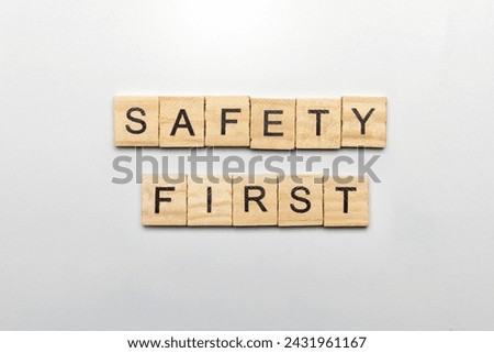 The row of wooden cubes with 'safety first' text on a white background. Safety first concept