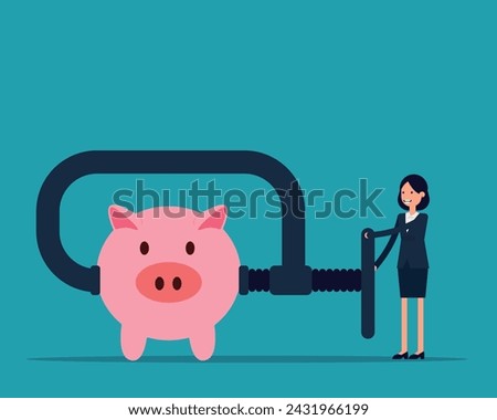Business person using clamp to squeeze saving pink piggy bank