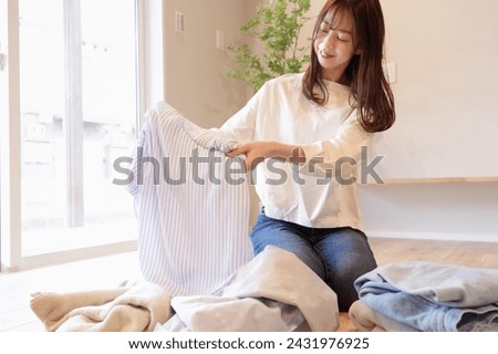 A young woman cleaning up the laundry