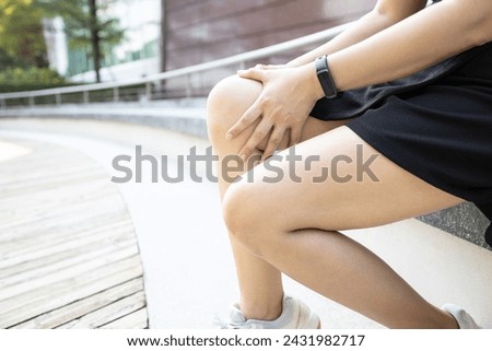 Middle aged woman holding knee,pain in kneecap or muscles around knee joint,patella friction against the thigh bone,disease of Runner's knee or Patellofemoral pain syndrome,ligament injury,health care Royalty-Free Stock Photo #2431982717