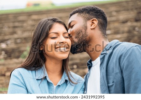 handsome man and beautiful woman hugging each other, walking, talking, having a date in the park Royalty-Free Stock Photo #2431992395