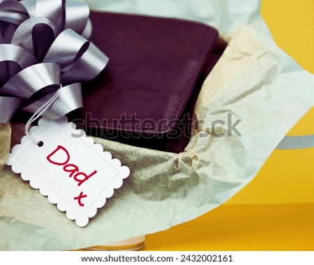 The image shows a pair of shoes placed on a yellow surface. The content provided is "Dad" and the tags include ribbon, wedding favors, craft, present, and gift wrapping.