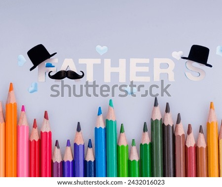 The image is of a group of colorful pencils. in background Fathers