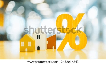 Percentage and house sign symbol icon wooden on wood table. Concepts of home interest, real estate, investing in inflation home loan interest rate hike. Royalty-Free Stock Photo #2432016243