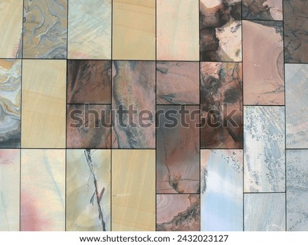 This high-resolution stock photo features a mosaic of natural stone tiles, each with its own unique pattern and palette of colors ranging from earthy tones to delicate pinks and bold streaks.