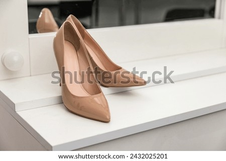 Women's high-heeled shoes in beige color. Classic elegant style