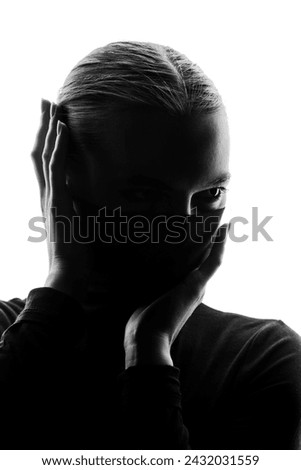 anonymous female silhouette in high contrast light Royalty-Free Stock Photo #2432031559