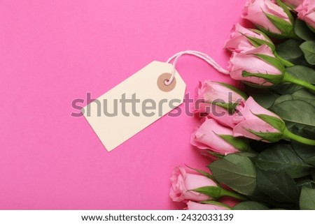 Happy Mother's day. Beautiful roses with tag on pink background, top view. Space for text