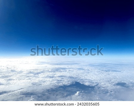 Image from flight seeing blue sky above clouds Royalty-Free Stock Photo #2432035605
