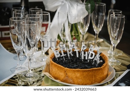 Happy birthday cake. Celebration birthday cake with silver candles spelling happy birthday on party Closeup.