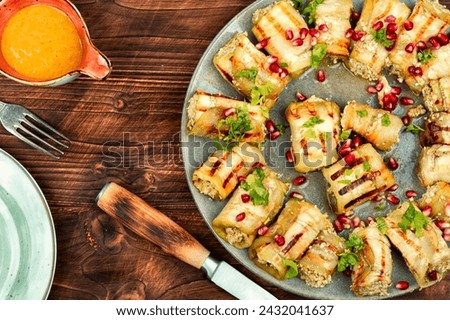 Badrijani, a Georgian dish, is a snack made from eggplant and meat. Eggplant rolls. Royalty-Free Stock Photo #2432041637