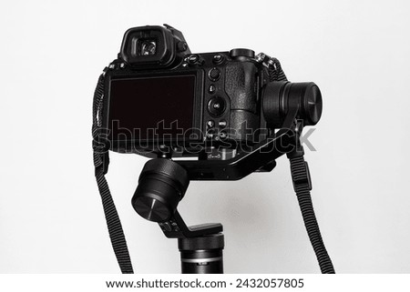 Black camera on a white background with stabilizer