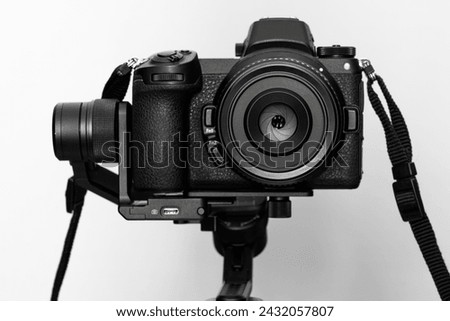 Black camera on a white background with stabilizer