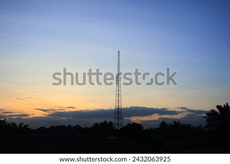 Telecommunication tower with sunset sky background in small village East Kalimantan Indonesia.