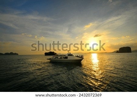 Big catamaran carry the traveler to see the sunset in the sea. Royalty-Free Stock Photo #2432072369