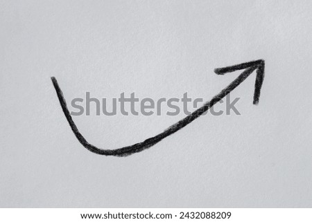 Hand drawn black arrow on white paper
