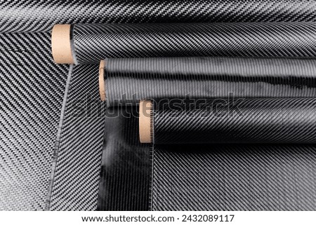 Rolls with various real woven carbon fiber enforcement raw material cloth. composite material industry and high tech background. 