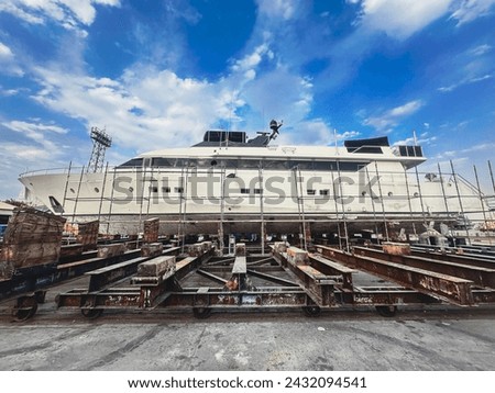 A boat hauled out for repair in dry dock Royalty-Free Stock Photo #2432094541