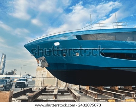 A blue beautiful yacht after repair in dry dock Royalty-Free Stock Photo #2432095073